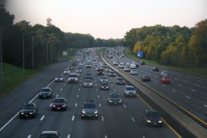 Motor traffic on Garden State Parkway, New Jersey, photographed in the evening. Most of the cars are southbound, moving from New York to the suburban homes in New Jersey.