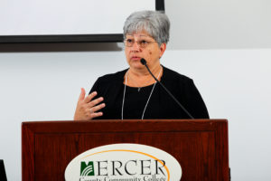Rebecca Savelli and Anthony Ennas sitting on a panel discussion
