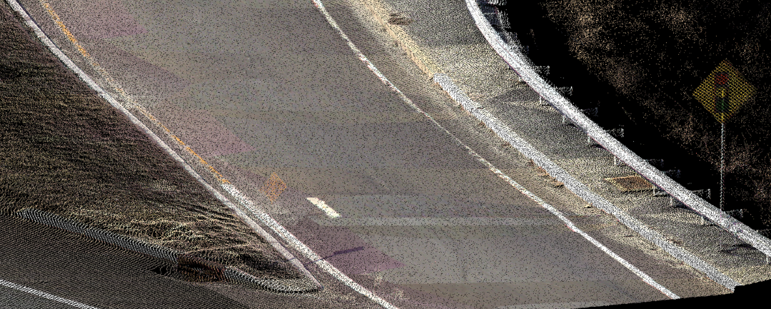 Figure 5. Low Cost As-Builts. In this view (RGB/real color mode) of the Route 55NB to Route 47 NB Ramp nose, assets such as signs, inlets, junction boxes, guide rail and post, striping, etc. are documented with true mapping grade 3D coordinates. The density of point cloud (approx. 4 to 5 mm apart) can be seen near the inlet/curb in the lower left.
