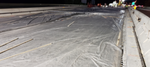 A bridge with a plastic cover at night, waiting for the UHPC to cure