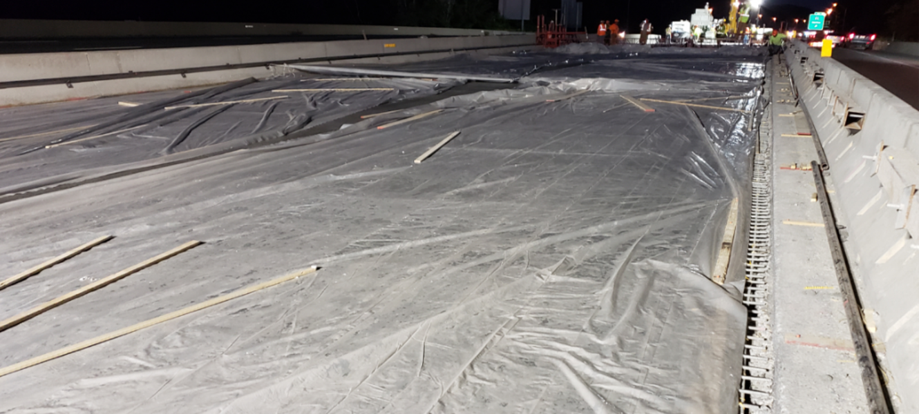 A bridge with a plastic cover at night, waiting for the UHPC to cure