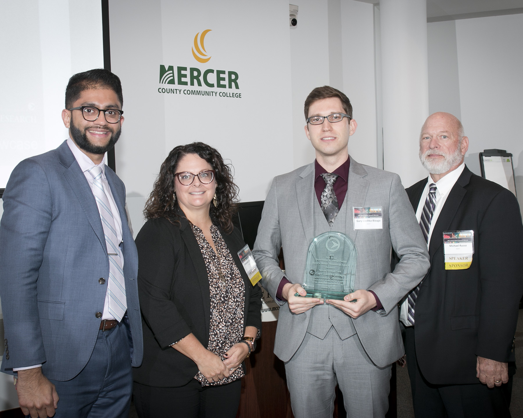 Accepting the Better Mousetrap Award, Gary Liedtka-Bizuga, Roadway Design Group 1, with Acting Assistant Commissioner Parth Oza, Bureau of Research Manager, Amanda Gendek, and Assistant Commissioner Michael Russo. Not shown here: Henry Jablonski, Region Central Construction. Photo by Steve Goodman.