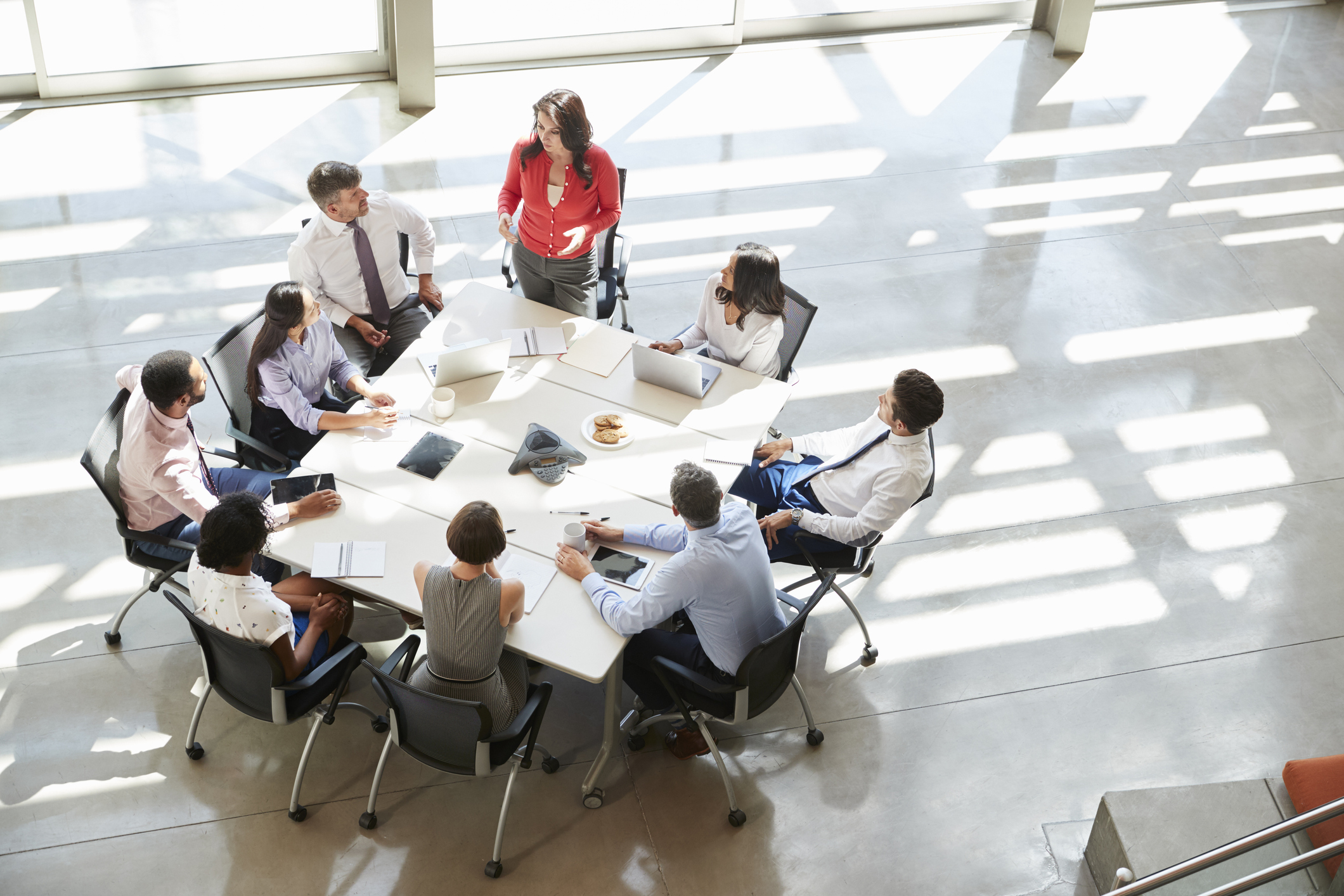 Businesswoman addressing team meeting, elevated view