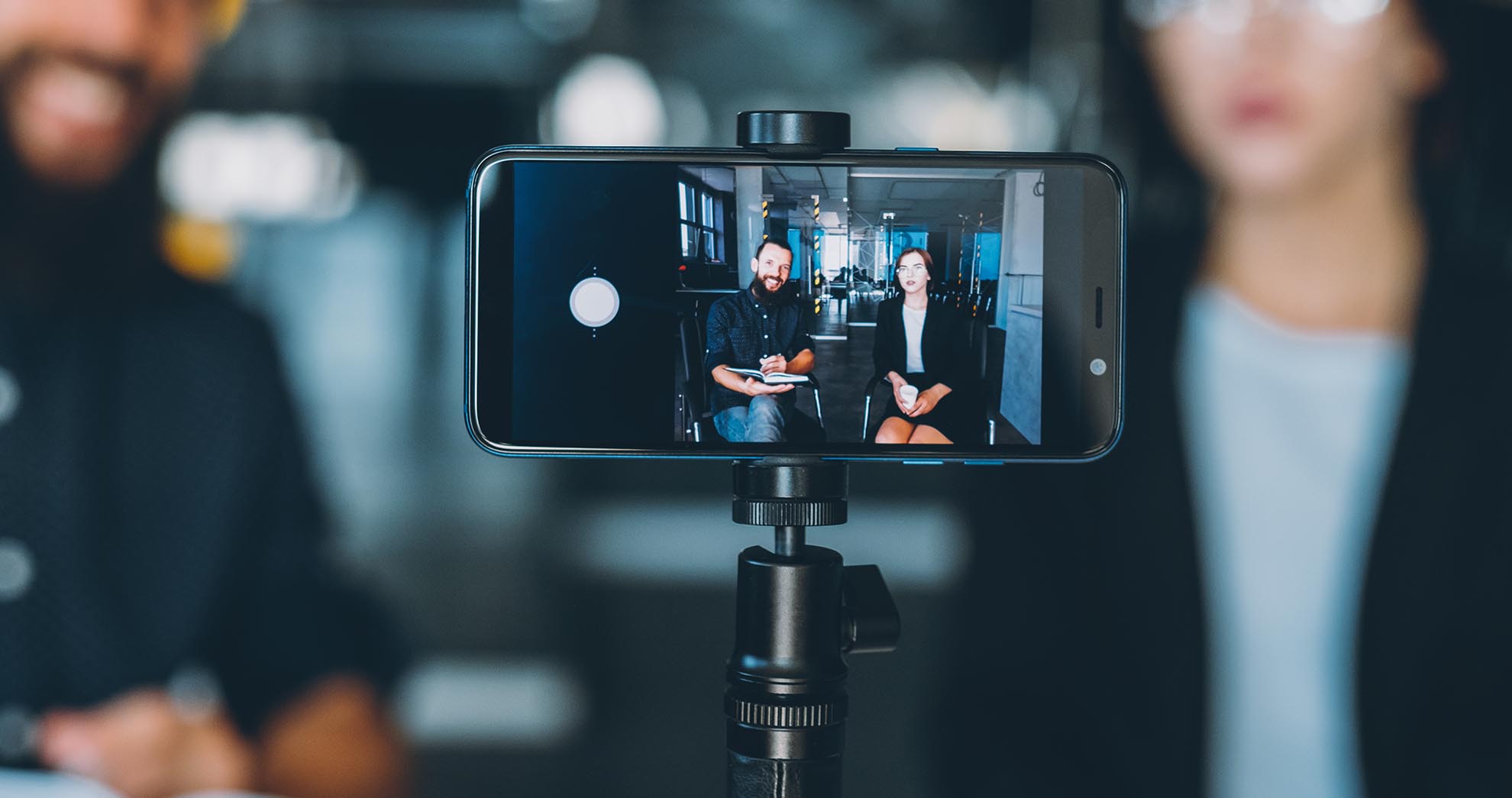 Business coaching. Management leadership. Partners recording video class with smartphone on tripod.